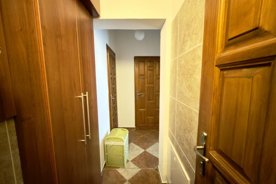 Hallway with built-in wardrobe and room doors