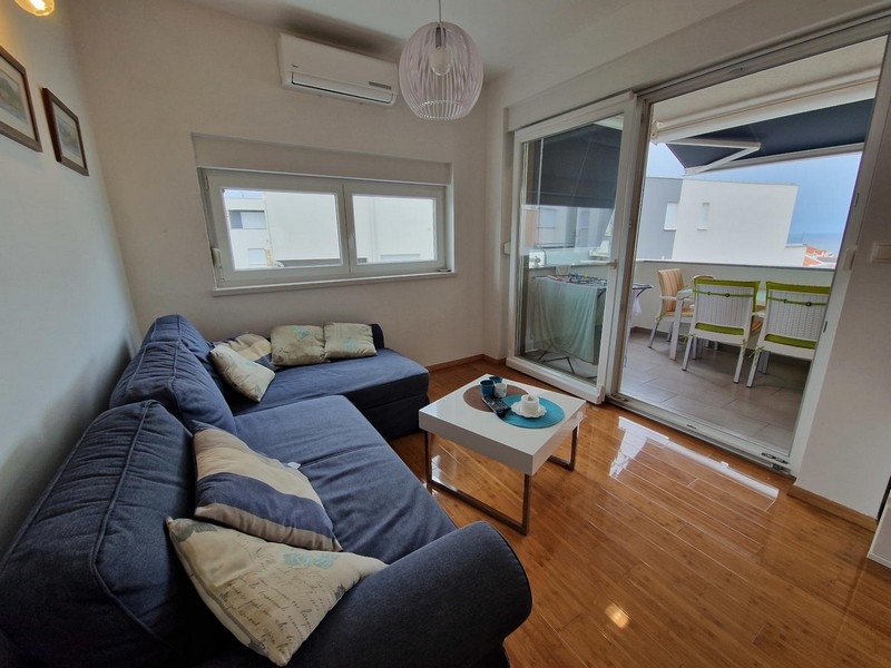 Living room with corner sofa and air conditioning
