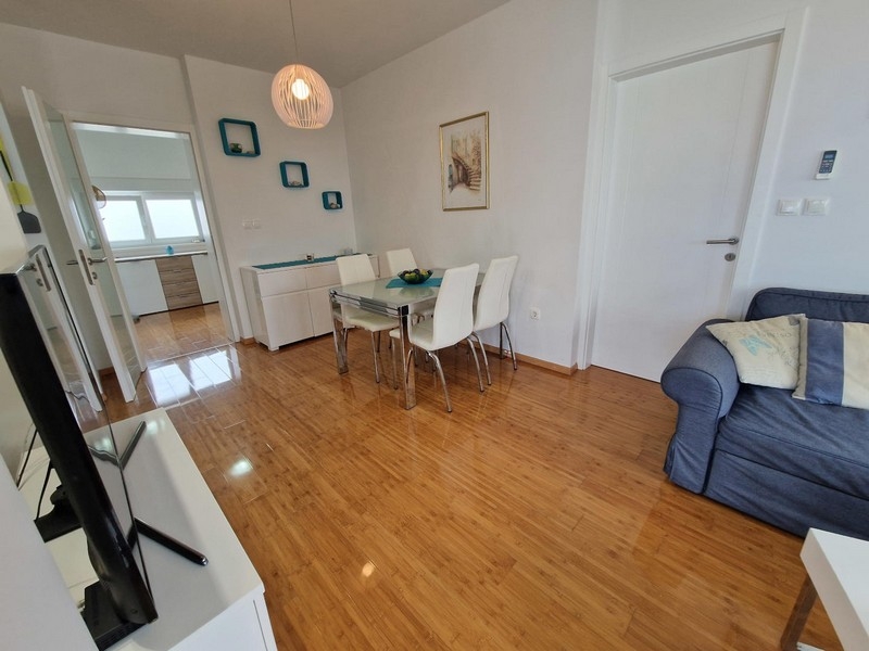 Living room with dining area and view of the kitchen