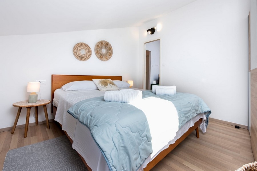 Bedroom with double bed and wooden floor