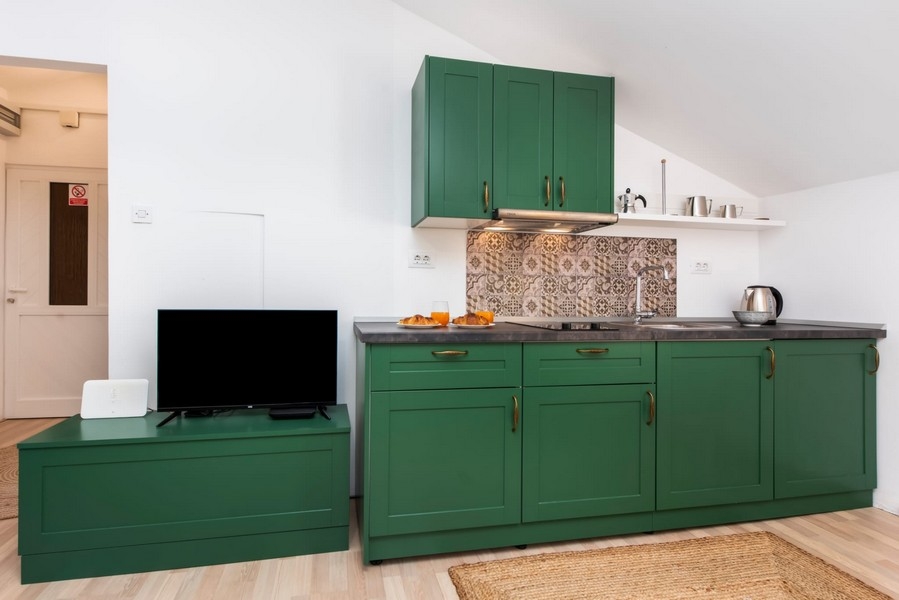 Green kitchenette with television