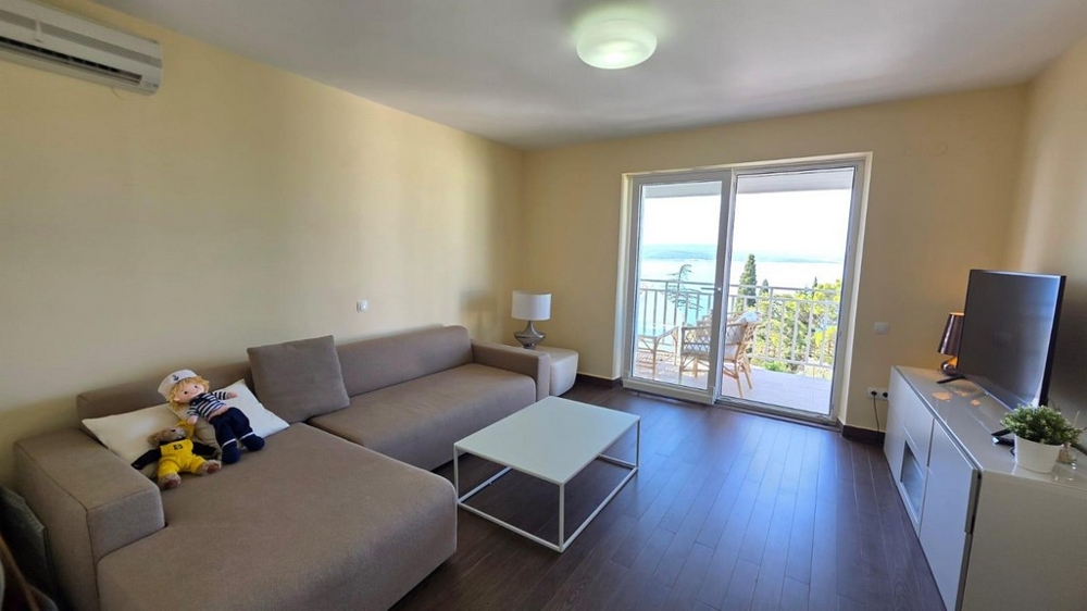 Living room with sofa and balcony access