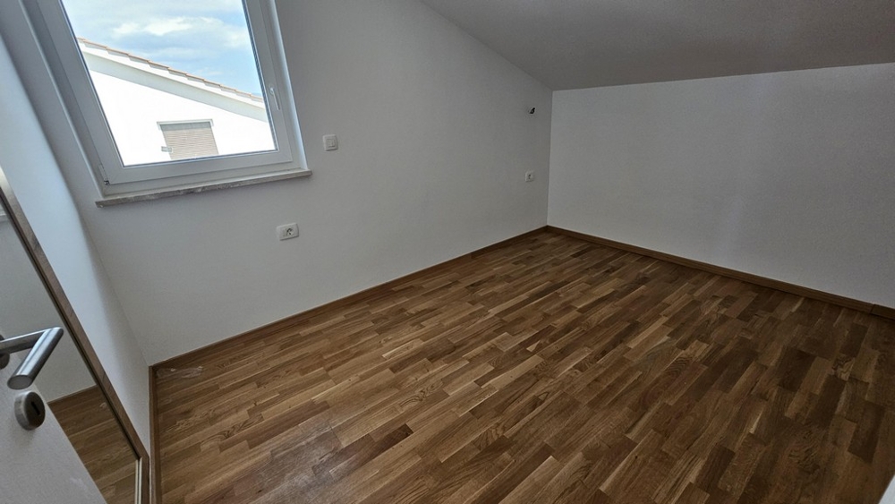 Bedroom with skylight and parquet floor