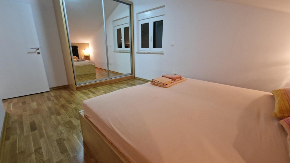 Bedroom with mirrored wardrobe in apartment on the island of Krk