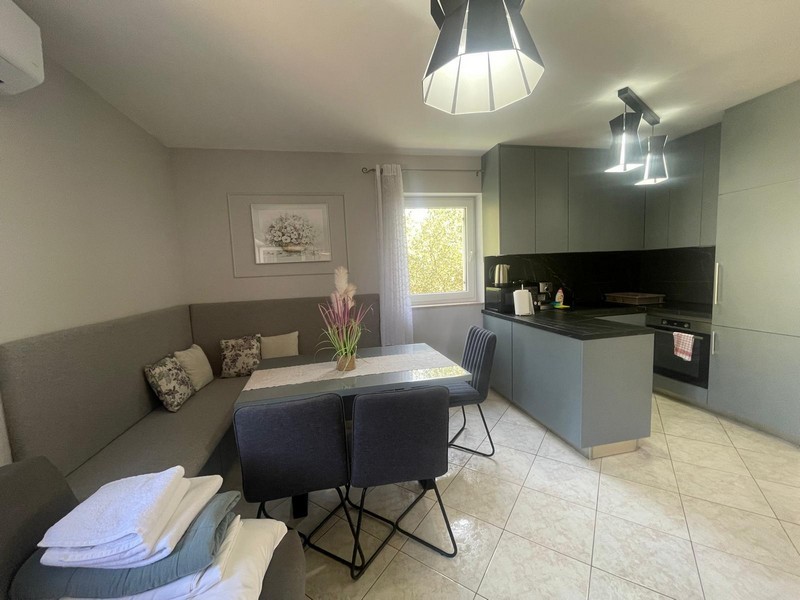 Living area with sofa and modern kitchen