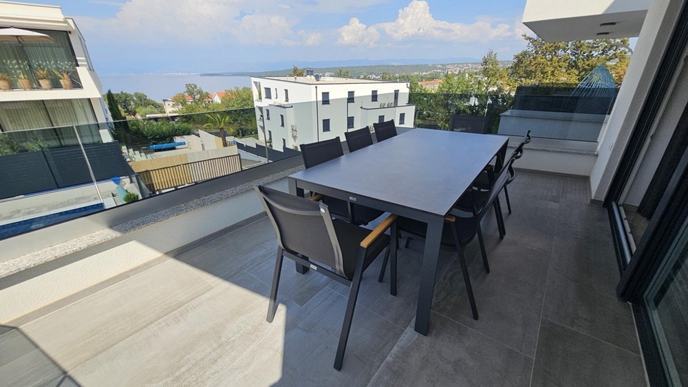 Covered terrace with dining area and sea view in Malinska on Krk
