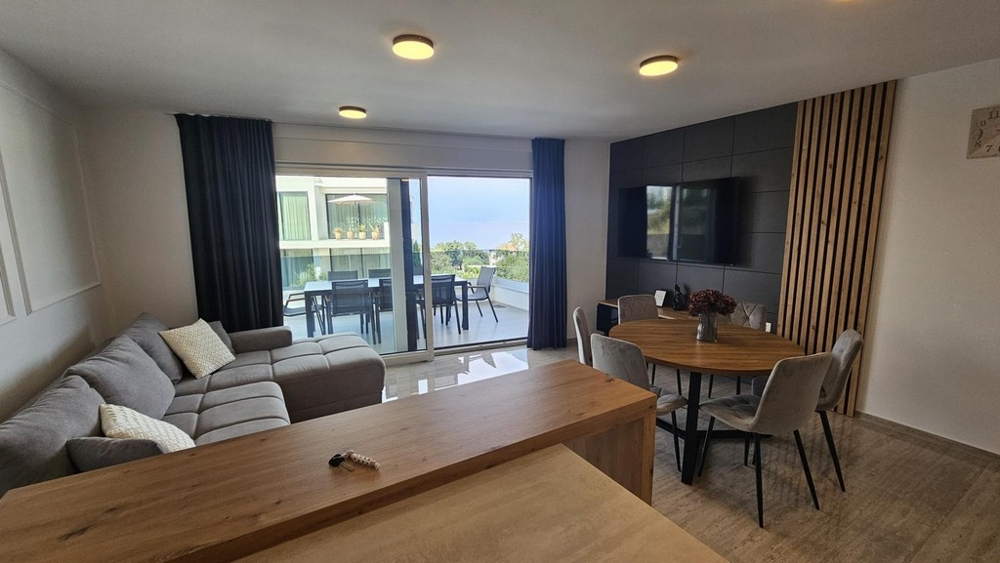 Living room with dining table and exit to the covered terrace