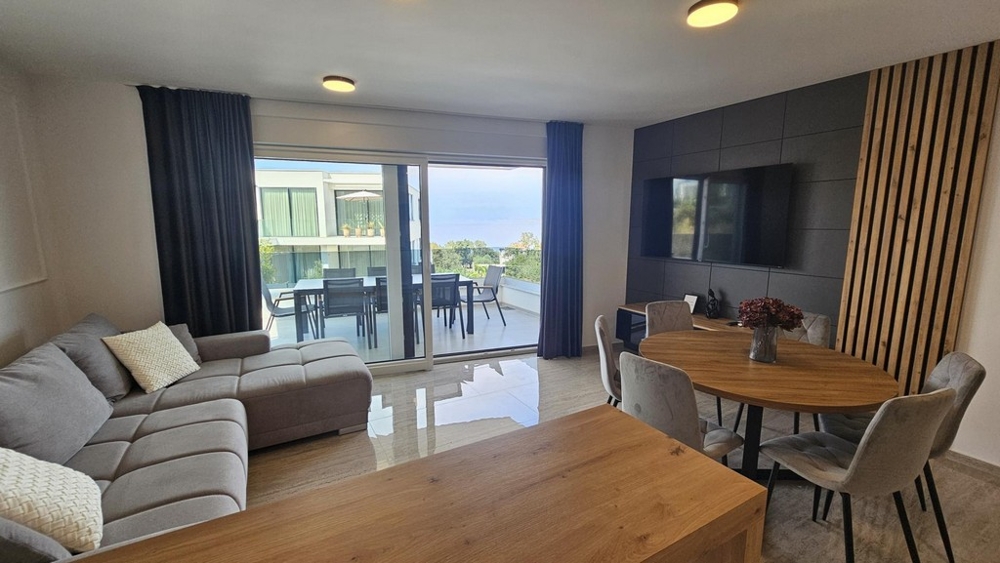 Living area with sea views through the window front of the apartment in Malinska