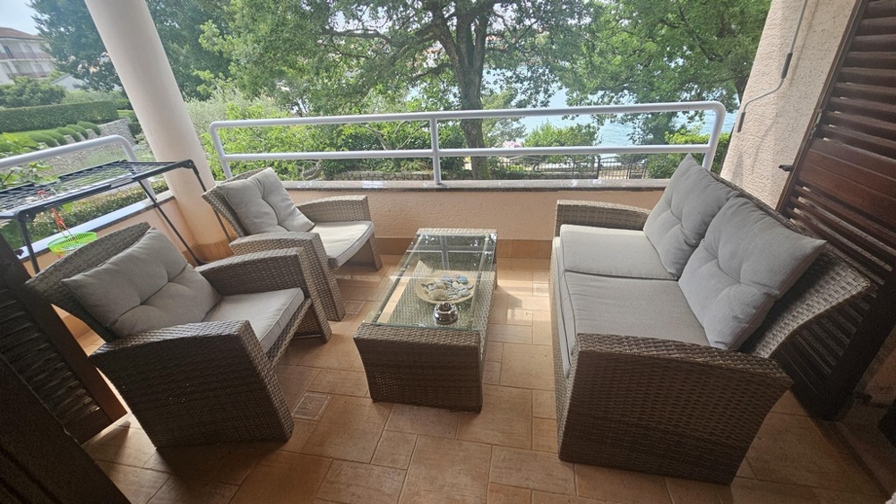 Covered balcony with lounge furniture and sea views