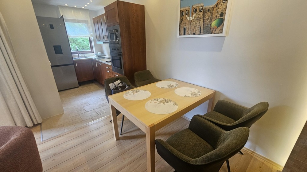 Dining area with wooden table and view of the kitchen