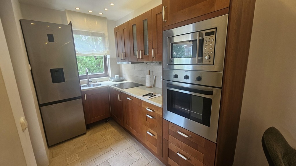 Fitted kitchen with oven and refrigerator