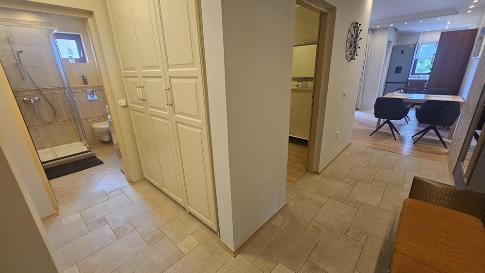 Hallway with built-in cupboard and view into the bathroom