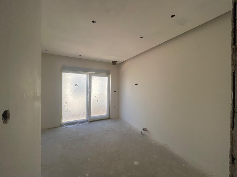 Room of the penthouse with French door to the balcony