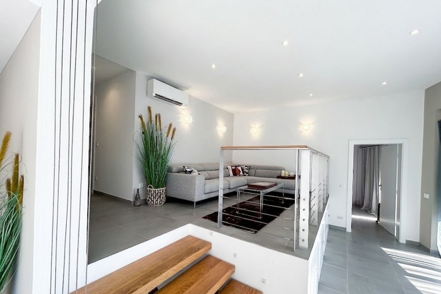 Elevated living area with sofa and wooden stairs, Korcula apartment