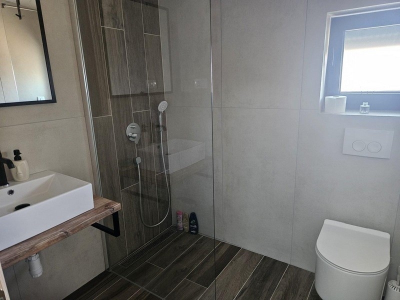Bathroom with shower and vanity