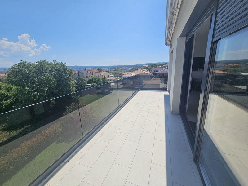 Large balcony with glass railings and sea views