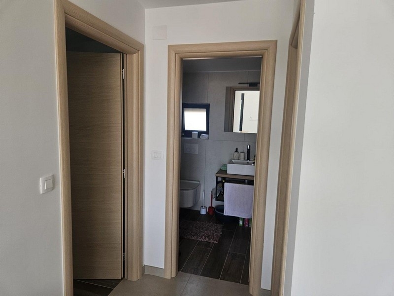 Hallway with access to the apartment's bathroom