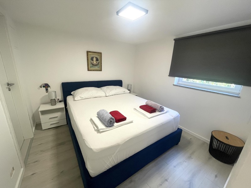 Bedroom with double bed in the ground floor apartment in Njivice