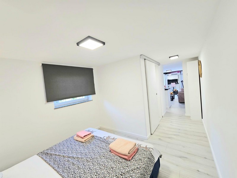 Sleeping area with double bed and view of Krk in the hallway