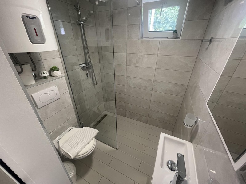 Bathroom with walk-in shower in apartment in Njivice