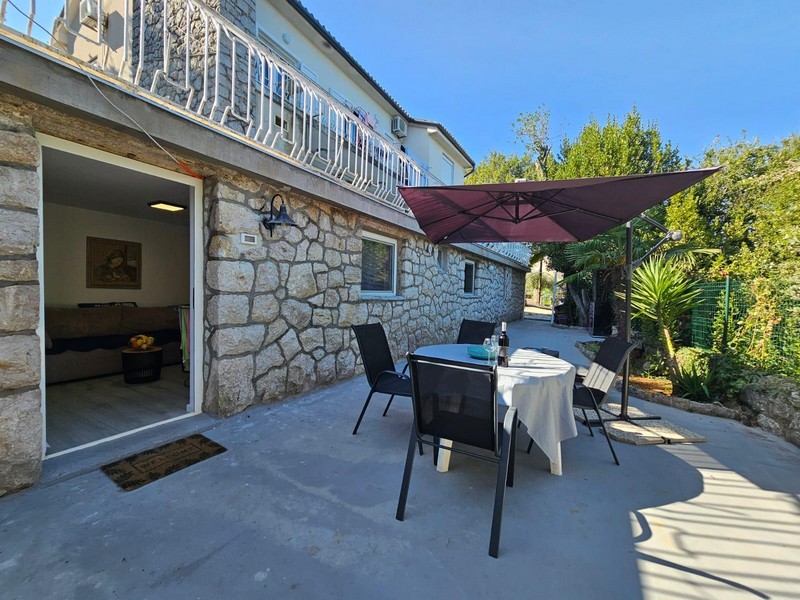 Seating group on the terrace in front of the stone house in Njivice on Krk