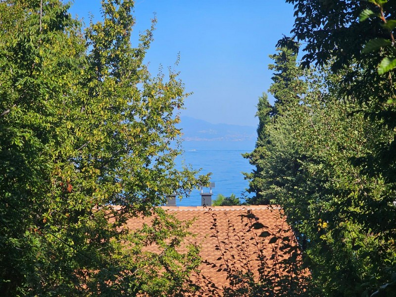 Sea view from the apartment in Njivice over the trees