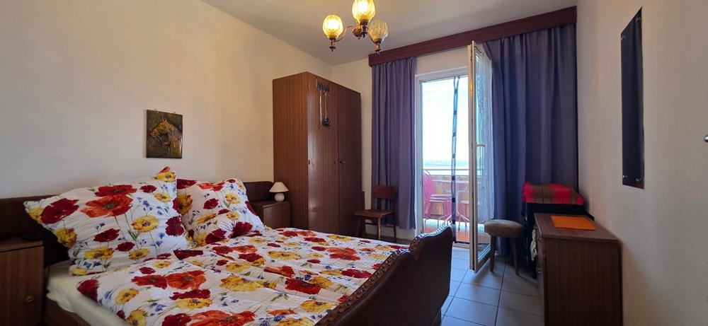 Bedroom with double bed and balcony door, apartment A4103