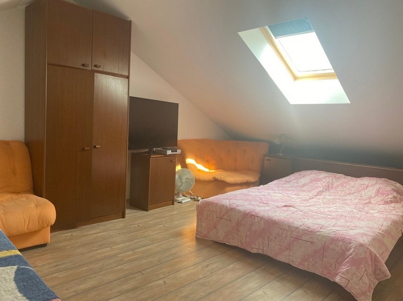 Bedroom under the sloping roof on the gallery