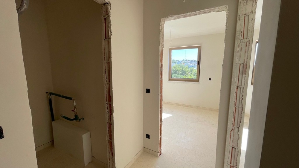View into the hallway with doors to the bathroom and bedroom