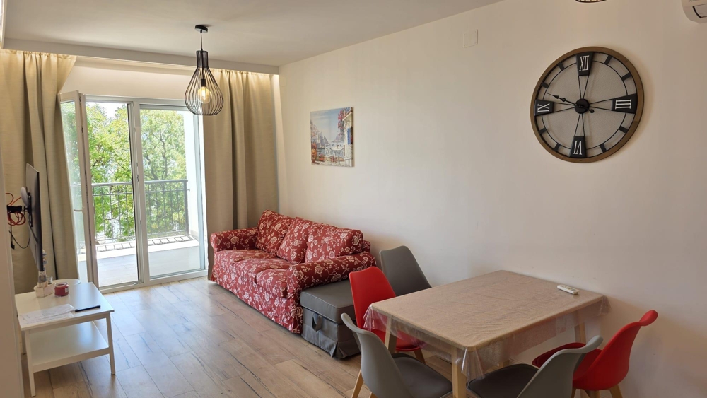 Living room with sofa and access to the loggia