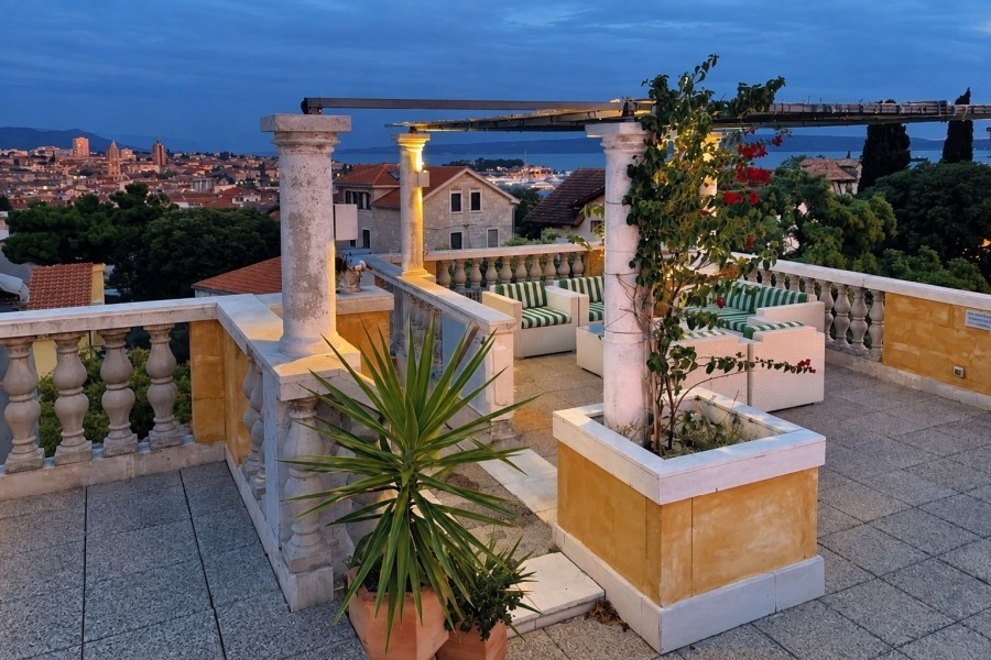 Roof terrace of the penthouse in Split with plants and evening views