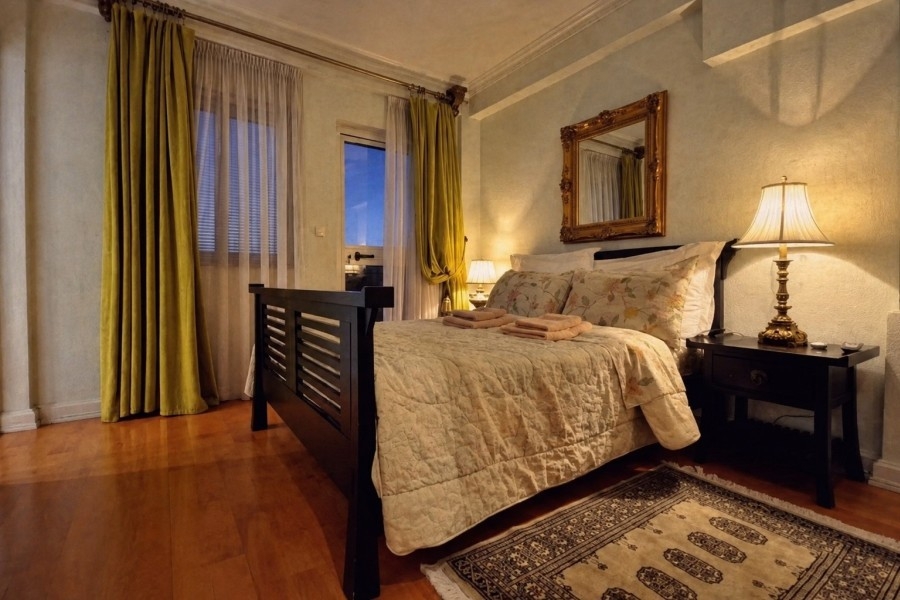 Bedroom with double bed and high windows