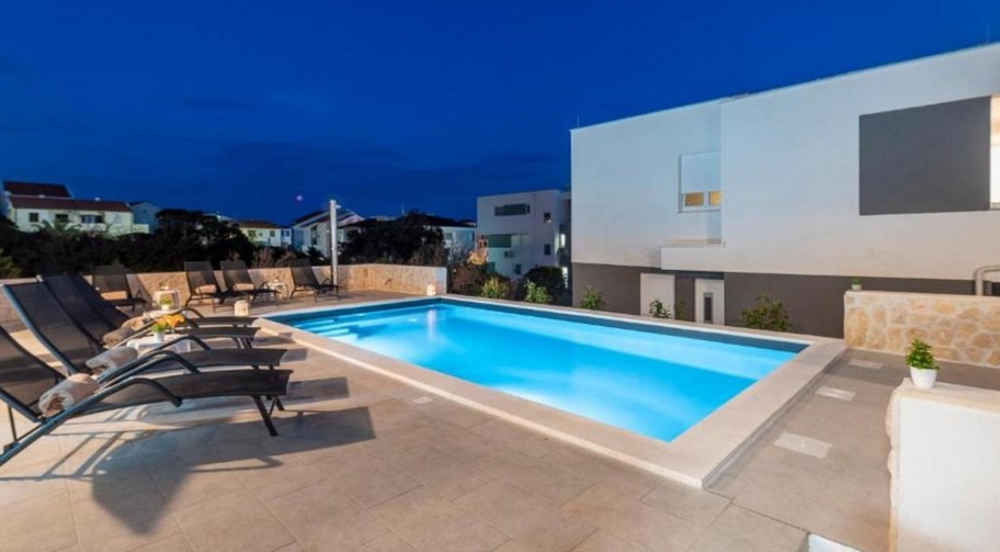 Pool of the residential complex in Novalja in the evening