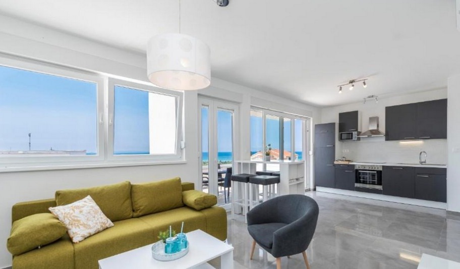 Living area with sofa and open kitchen