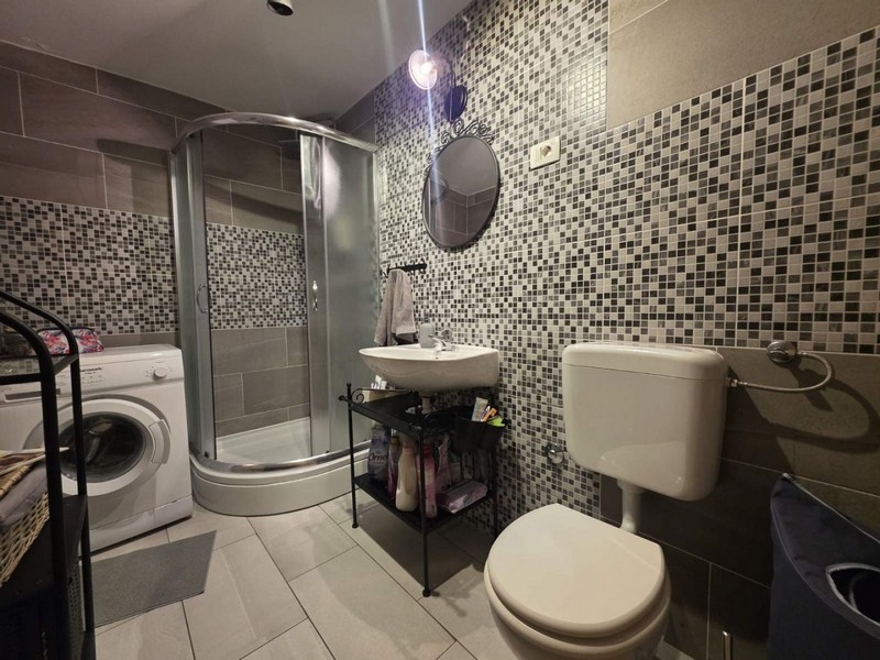 Bathroom with shower and washing machine