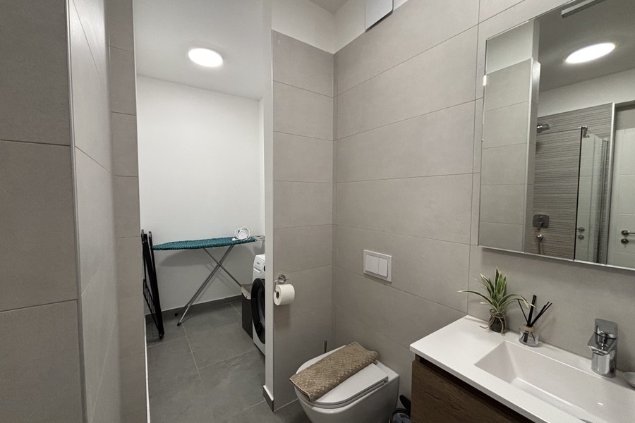 Bathroom with toilet and mirror in the penthouse in Trogir