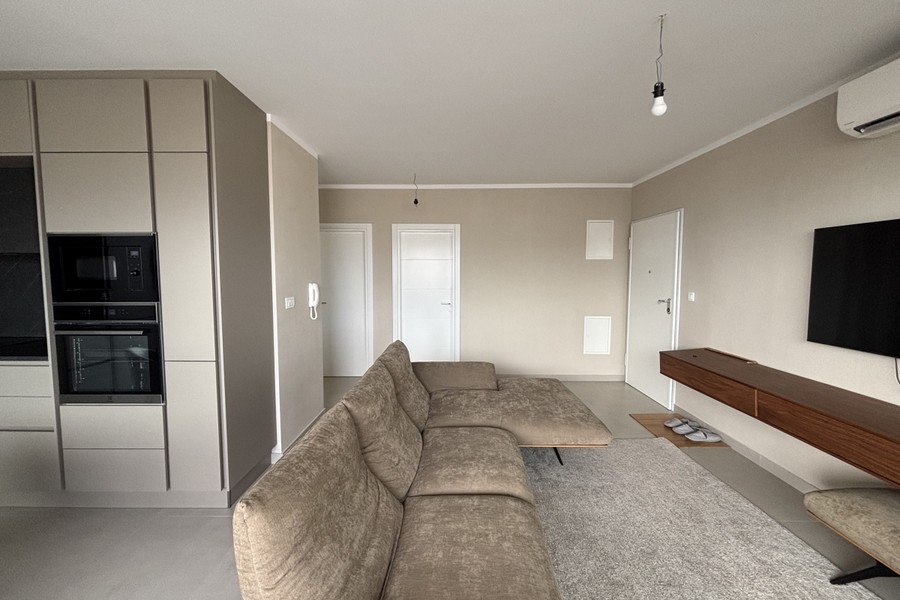 Living area with TV and open kitchen