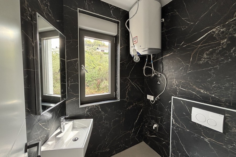 Bathroom with dark marble tiles
