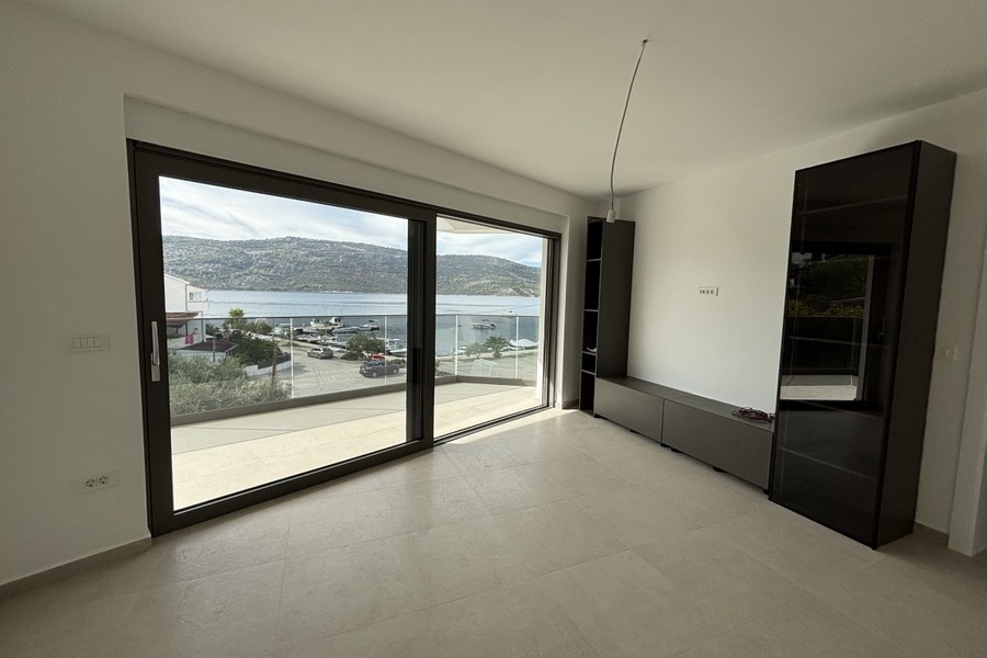 Living room with floor-to-ceiling windows and sea views