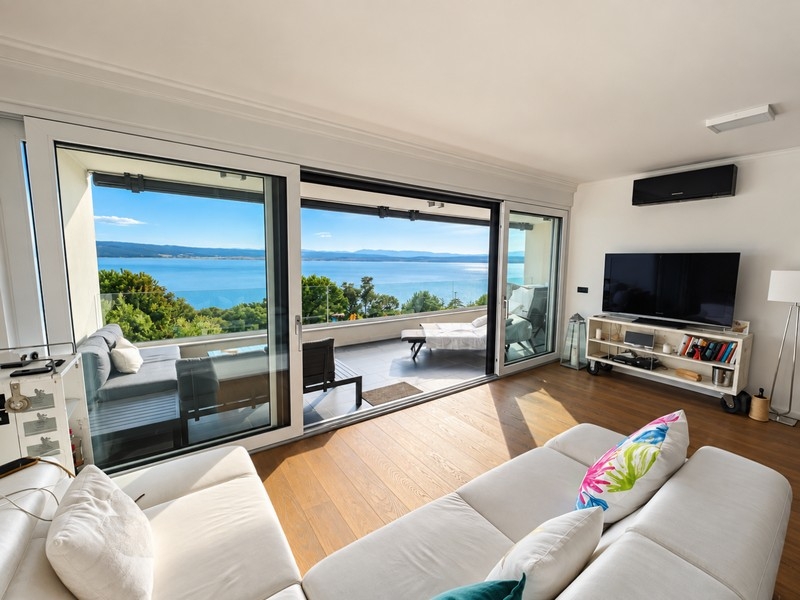 Living room with large window front facing the sea