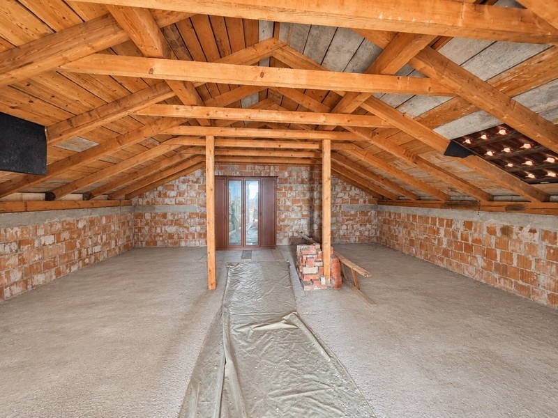 Attic in the shell with wooden roof trusses