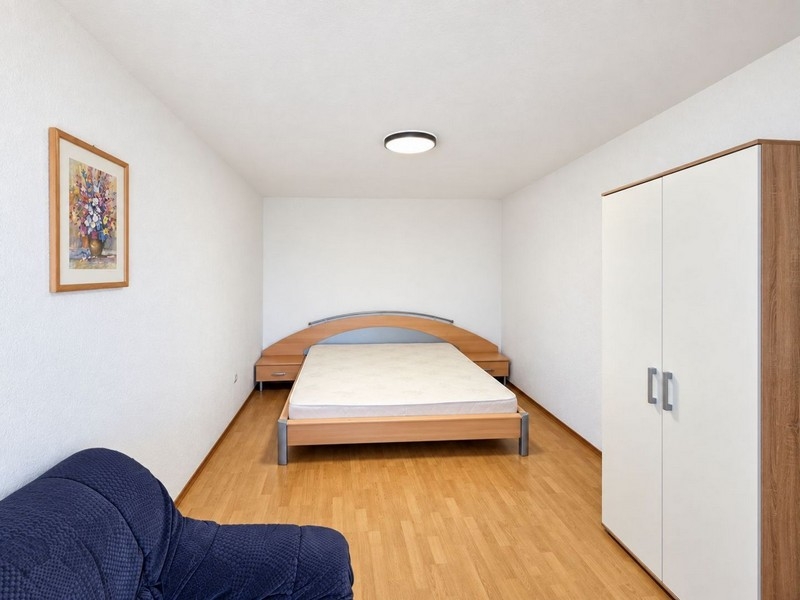 Bedroom with double bed and armchair