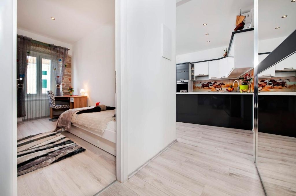 Bedroom with a view of the kitchen