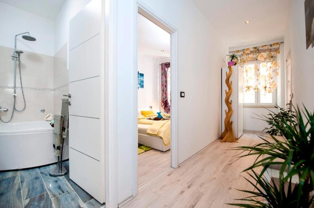 Bathroom with corner bathtub and rain shower