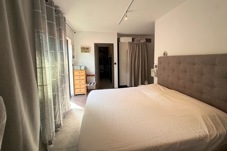 Bedroom with double bed and upholstered headboard