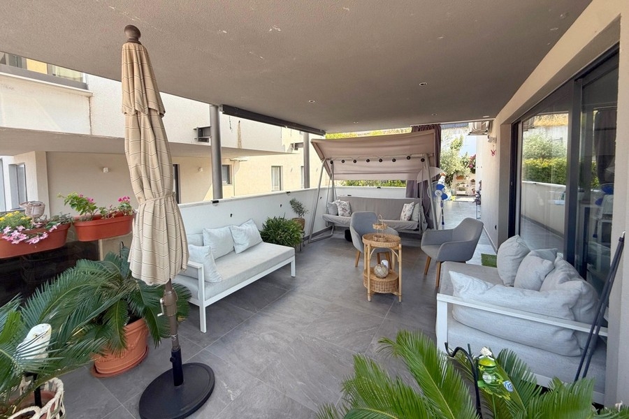 Covered terrace with seating in front of the living area