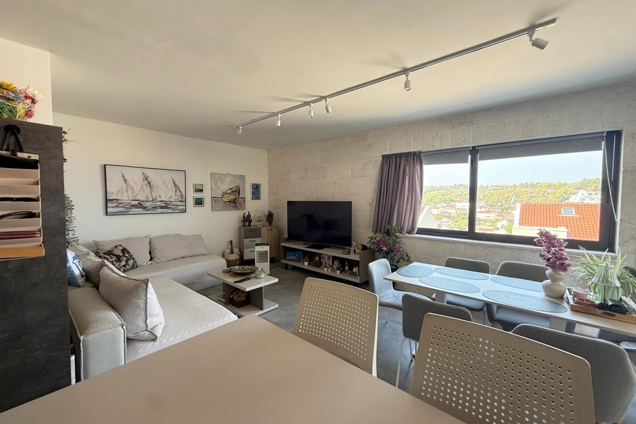 Living area with window and view of the greenery