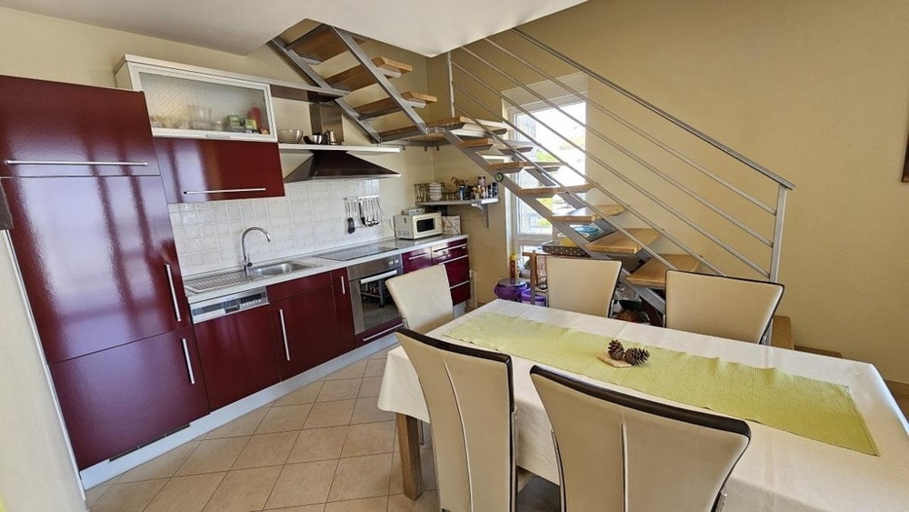 Open kitchen with dining area and stairs