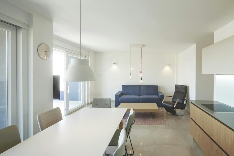 Open living room with sofa and kitchen island