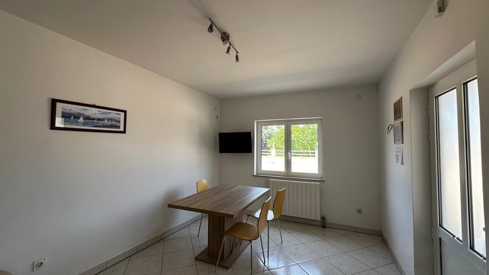 Living room with dining table and window to the terrace